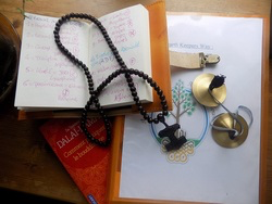 prayer beads over a copy of the Hearth Keepers Way and personal journal